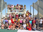 The members of the Lamplighters theme camp pose in four tiers for a group photo.