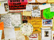 Notes and handbills of all shapes, sizes and colors cover an easel.